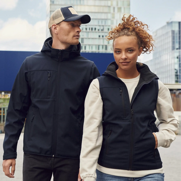 Black soft-shell vest with a hood and front zipper, worn over a cream-colored long-sleeve shirt.